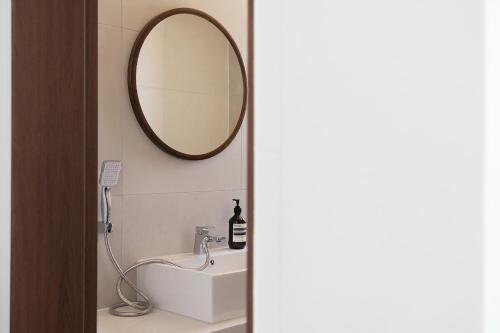 a bathroom with a sink and a mirror on the wall at Soye stay in Gyeongju