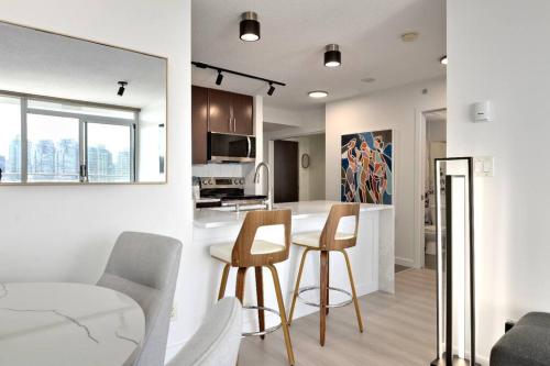 a kitchen with a table and chairs in a room at Luxary Condo Downtown Vancouver with free parking in Vancouver