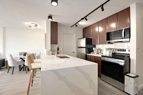 a kitchen with a sink and a stove top oven at Luxary Condo Downtown Vancouver with free parking in Vancouver
