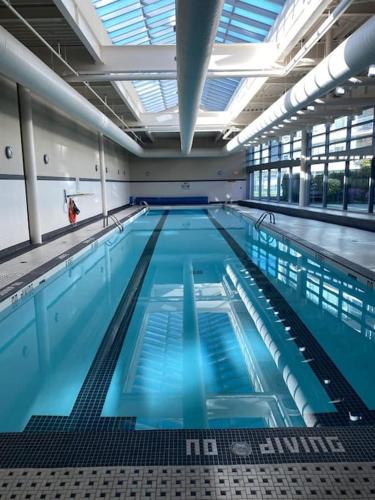 a large swimming pool with blue water at Luxary Condo Downtown Vancouver with free parking in Vancouver