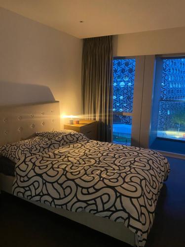 a bedroom with a large bed and a window at Luxury stay near O2 and canary wharf in London
