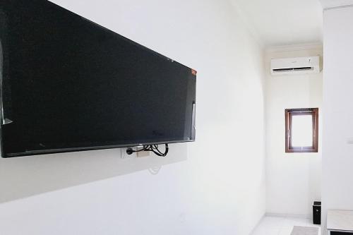 a flat screen tv hanging on a wall at Sendang Syariah RedPartner in Kediri