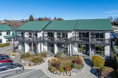an aerial view of a large house with a green roof at Lake Tekapo Village Motel in Lake Tekapo