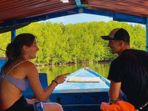 a man and a woman on a boat on the water at Sunari Beach Resort Selayar - Real in Pareangang