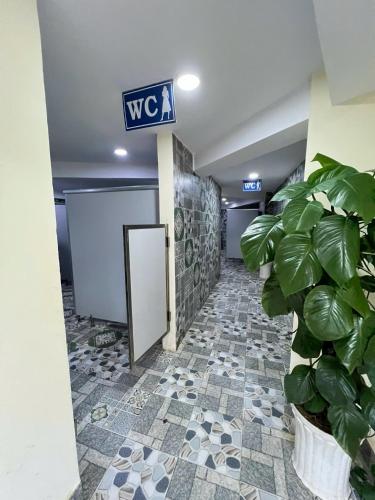 a hallway with a sign and a potted plant at Khu Du Lịch Tea Bobla Waterfall in Di Linh
