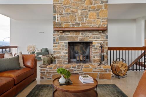 a living room with a brick fireplace at Lachlan Retreat,Trevallyn in Launceston