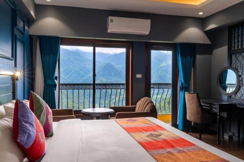 a bedroom with a bed with a view of a mountain at Sapa Charm Hotel in Sapa