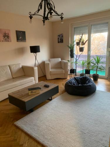 a living room with a couch and a coffee table at Relax apartman in Siófok