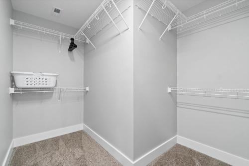 a walk in closet with white walls and shelves at Rebecca's Downtown Luxury Living (527 N 1st St, #C) in Clarksville