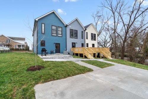 a blue house with a porch and a deck at Rebecca's Downtown Luxury Living (527 N 1st St, #C) in Clarksville