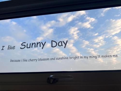 a window in a car with the words sunny day at Leo66 Guesthouse in Kampung Tanjung Agas