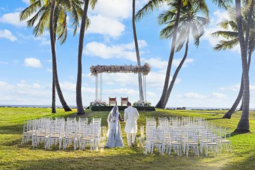 a bride and groom walking down the aisle at their wedding ceremony at Sheraton Fiji Golf & Beach Resort in Denarau