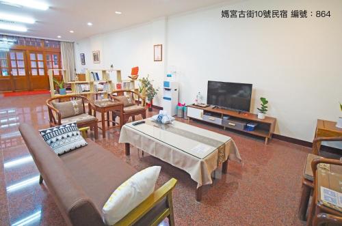 a living room with furniture and a flat screen tv at 媽宮古街10號 in Magong