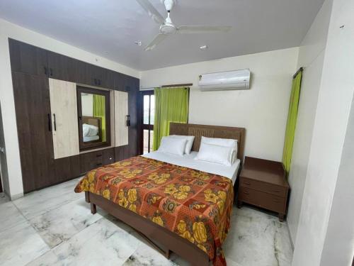 a bedroom with a bed and a ceiling fan at Aashvi homes - Rooms with Balcony in Jaipur