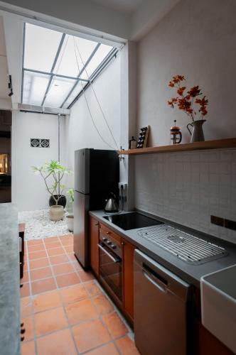 a kitchen with a refrigerator and a stove top oven at Carnarvon Villa by Aayu George Town Penang in George Town