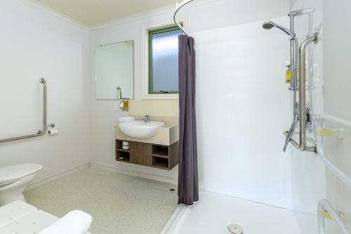 a bathroom with a sink and a toilet at Lake Tekapo Village Motel in Lake Tekapo