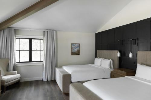 a hotel room with two beds and a chair at Homestead Resort in Midway