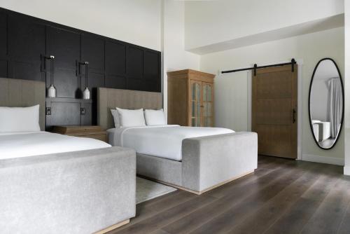 a hotel room with two beds and a mirror at Homestead Resort in Midway
