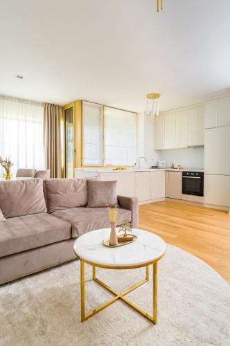 a living room with a couch and a table at Mido Aviatie Park Apartments with Private Parking & Self Check-in in Bucharest