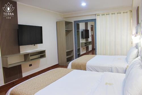 Katil atau katil-katil dalam bilik di Terra Premium Hotel