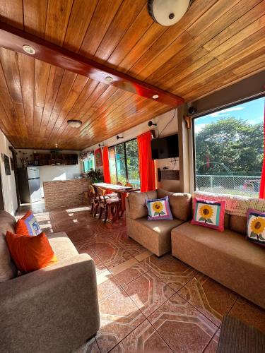 a living room with two couches and a table at Lidia's Mountain View Vacation Homes in Monteverde Costa Rica