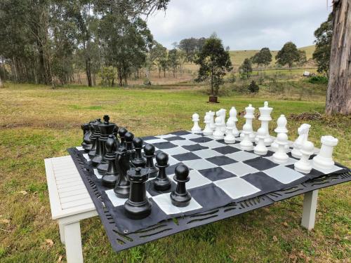 a chess set on a table in a field at Lambs Valley Guest House. in Lambs Valley