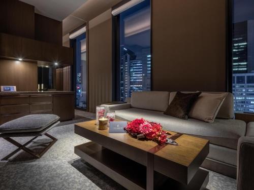 a living room with a couch and a table at Hotel The Celestine Ginza in Tokyo