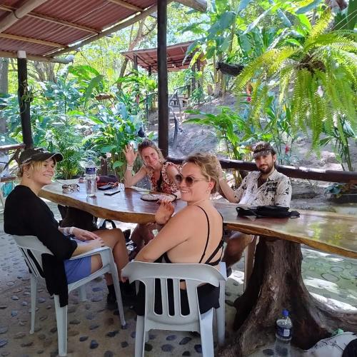 a group of people sitting at a table in a restaurant at HOSTAL MIRADOR dentro del parque tayrona in El Zaino