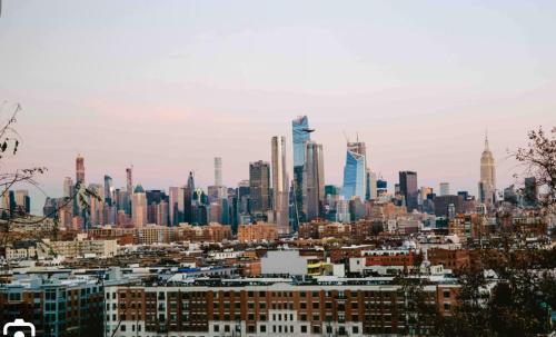 a view of a city skyline with skyscrapers at Sunny Apt by the park Mins away from midtown New York in Jersey City