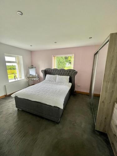 a bedroom with a large bed in a room at Unique countryside stay in Dundrod