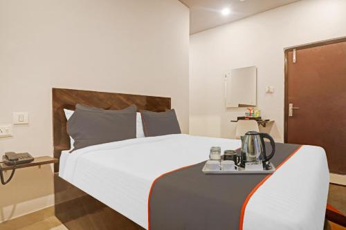a hotel room with a bed and a table at Super Townhouse RCC Pristine in Hyderabad