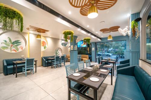a dining room with tables and chairs in a restaurant at Treebo Kamal Regency in Bhopal