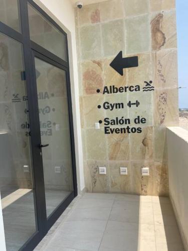 a sign on the side of a building next to a door at New and spacious apartment in Velamar in Altamira