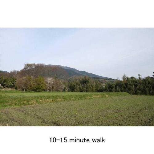 a picture of a field with a mountain in the background at Cochi Stay, for architecture lovers in Nagara