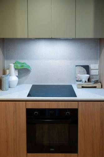 Oaks Canopy - Boutique 1 & 2 BR Apartmentsにあるキッチンまたは簡易キッチン