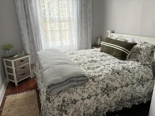 a bedroom with a bed and a window at Cambridge Cottage in Cambridge