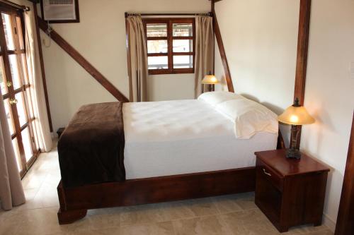 um quarto com uma cama e duas lâmpadas sobre uma mesa em Casa Aventura em San Clemente