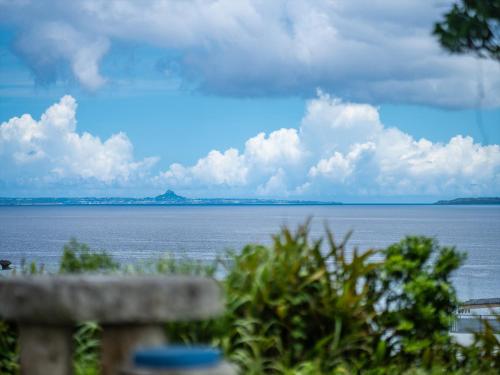 a view of the ocean from a bench at Oriental Hills Okinawa in Onna
