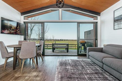 a living room with a couch and a table at Black Label Retreats in Gisborne