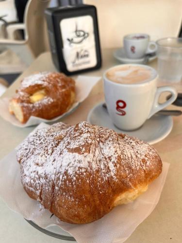 a table with two pastries and a cup of coffee at B&b La Campanella in Palagianello