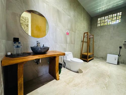 a bathroom with a sink and a toilet at Cozy room J in Uluwatu near beach,by d'ulu villa in Uluwatu