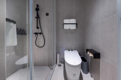 a small bathroom with a shower and a toilet at Atour Light Hotel Nanjing Xinjiekou Presidential Palace in Nanjing
