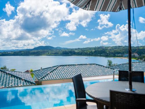 a view of a lake from a patio with a table at Oriental Hills Okinawa in Onna
