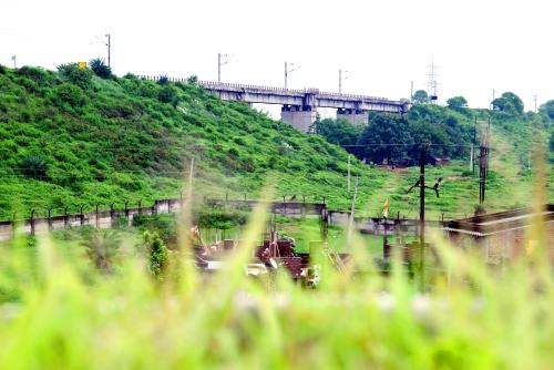 a bridge over a hill with a train on it at Shivay Guest house in Jasidih