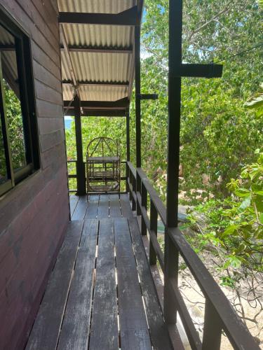 a wooden porch with a cross on the side of a building at Tao Thong Villa 1 in Koh Tao
