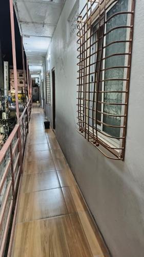 a hallway of a store with wooden floors and windows at Nain Guest House in Ujjain