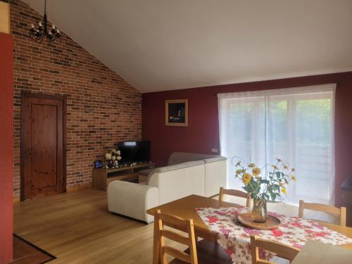 a living room with a dining room table and a couch at Cozy Corner in Saulkrasti