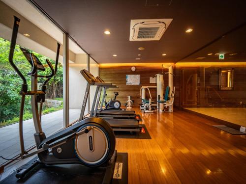 a gym with treadmills and a treadmill in a room at Oriental Hills Okinawa in Onna