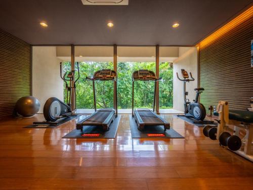 a gym with a row of treadmills in a room at Oriental Hills Okinawa in Onna