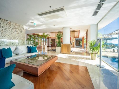 a living room with a couch and a table at Oriental Hills Okinawa in Onna